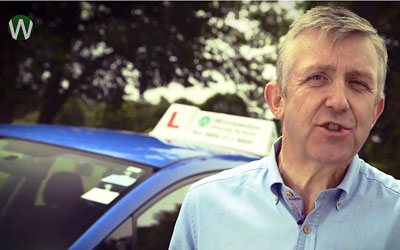 Still of Alastair Greener, presenter of the Wimbledon Driving School video